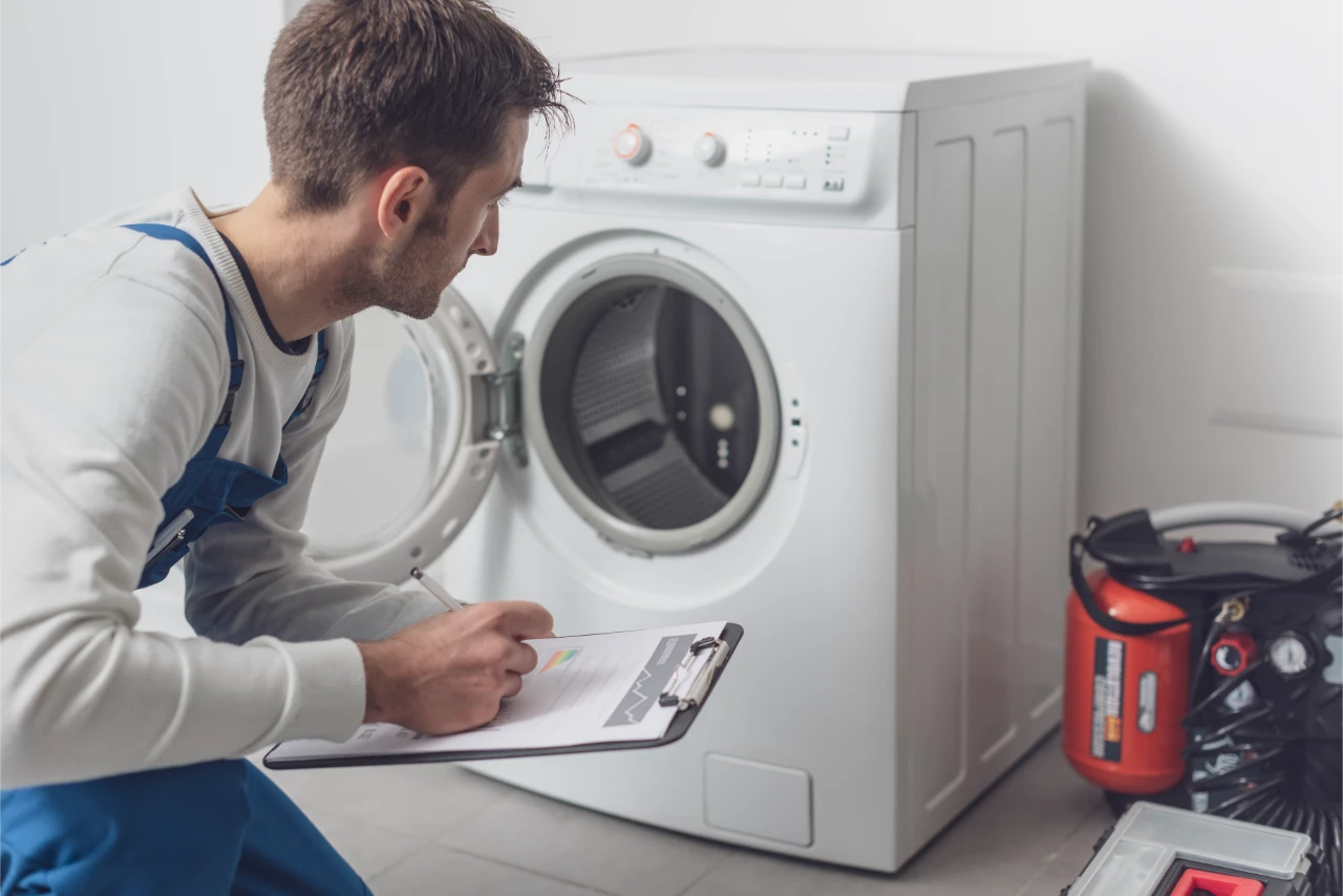 professional technician checking washing machine